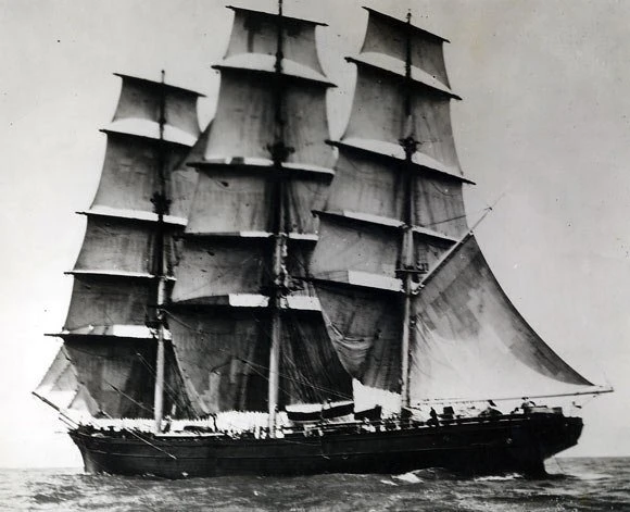 Historic black and white photograph of the Cutty Sark clipper ship at sea.