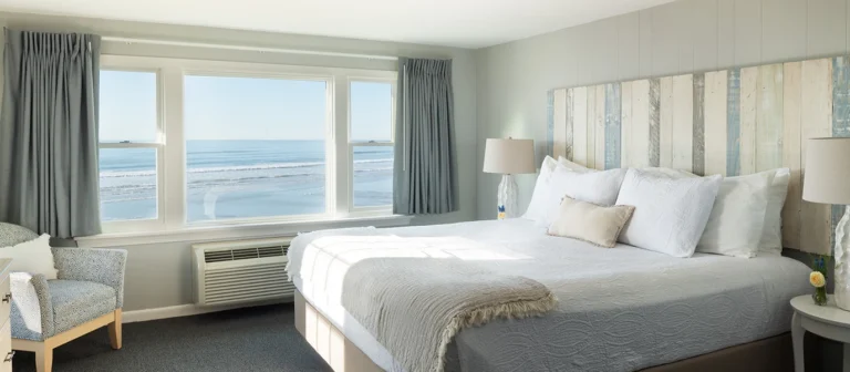 Spacious oceanfront king room with large picture windows overlooking Long Sands Beach.