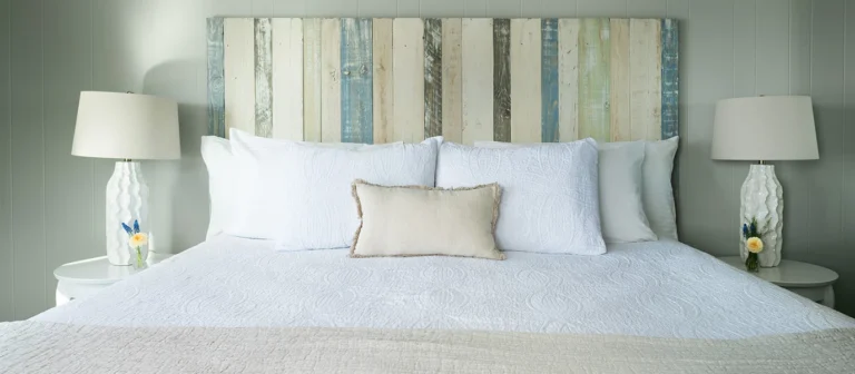 Comfortable king bed with coastal decor and soft natural tones in an oceanfront guest room.