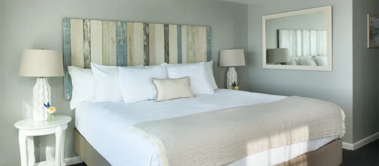Bright coastal-inspired king bedroom with updated furnishings and relaxing oceanfront ambiance.