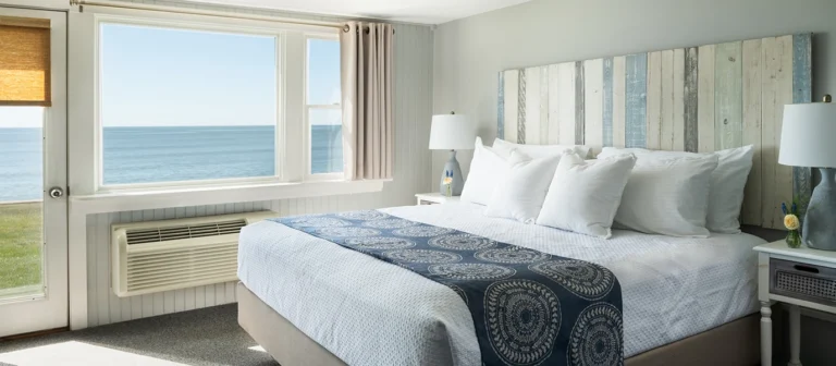 Oceanfront king guest room with panoramic beach views.
