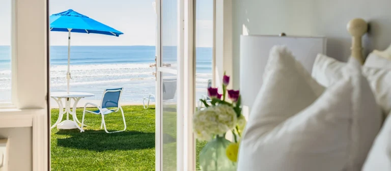 Oceanfront guest room with direct lawn access and beach views.