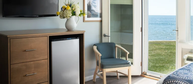 Oceanfront guest room interior with direct lawn access and beach views.