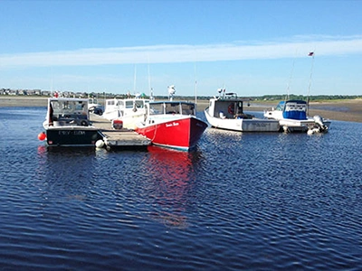 Fishing boats docked along the water in York, Maine during Memorial Day Weekend.