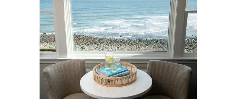 Upper building second- and third-floor king room with corner ocean views and a cozy window seating area.