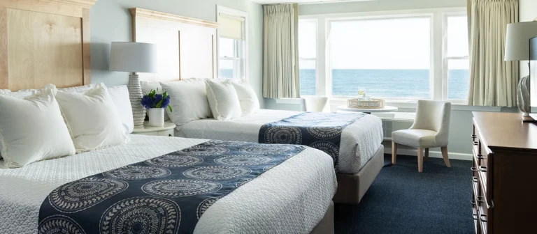 Oceanfront guest room with two queen beds at Cutty Sark Motel in York Maine with large windows overlooking the Atlantic