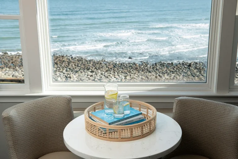 Upper building second- and third-floor king room with corner ocean views and a cozy window seating area.